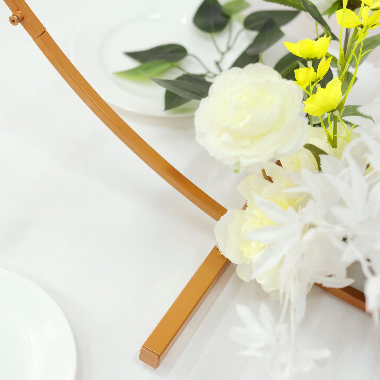 Gold metal round hoop wedding centerpiece with floral accents.