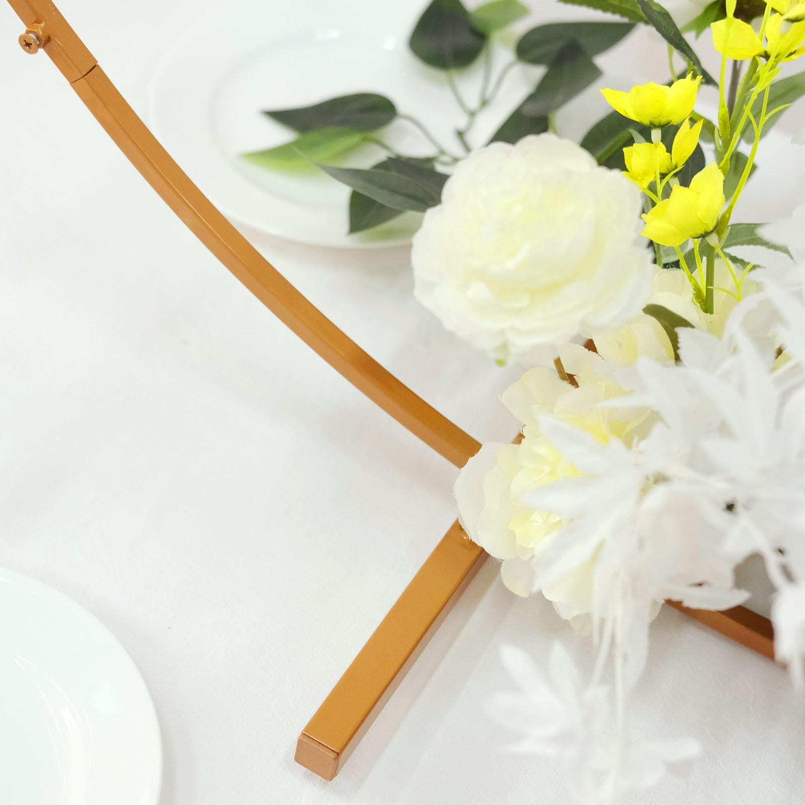 Gold metal round hoop wedding centerpiece with floral accents.
