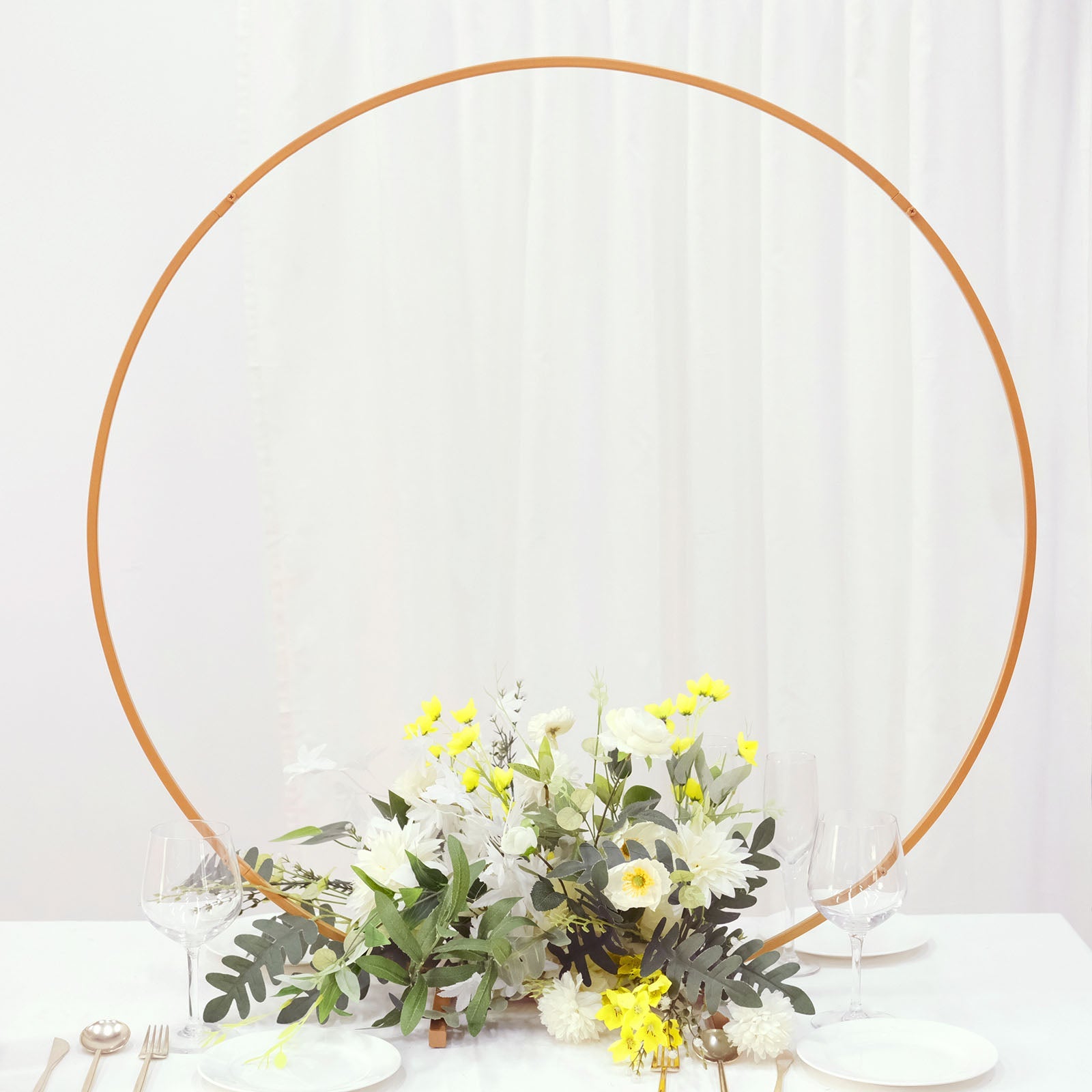 36" gold metal round hoop wedding centerpiece with floral arrangement.