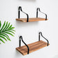 Wood and metal floating wall shelves with a natural wood finish and black straps.