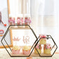 Black geometric 2-tier hexagon floating shelf displaying desserts.