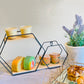 Black geometric floating shelf displaying colorful desserts and drinks.