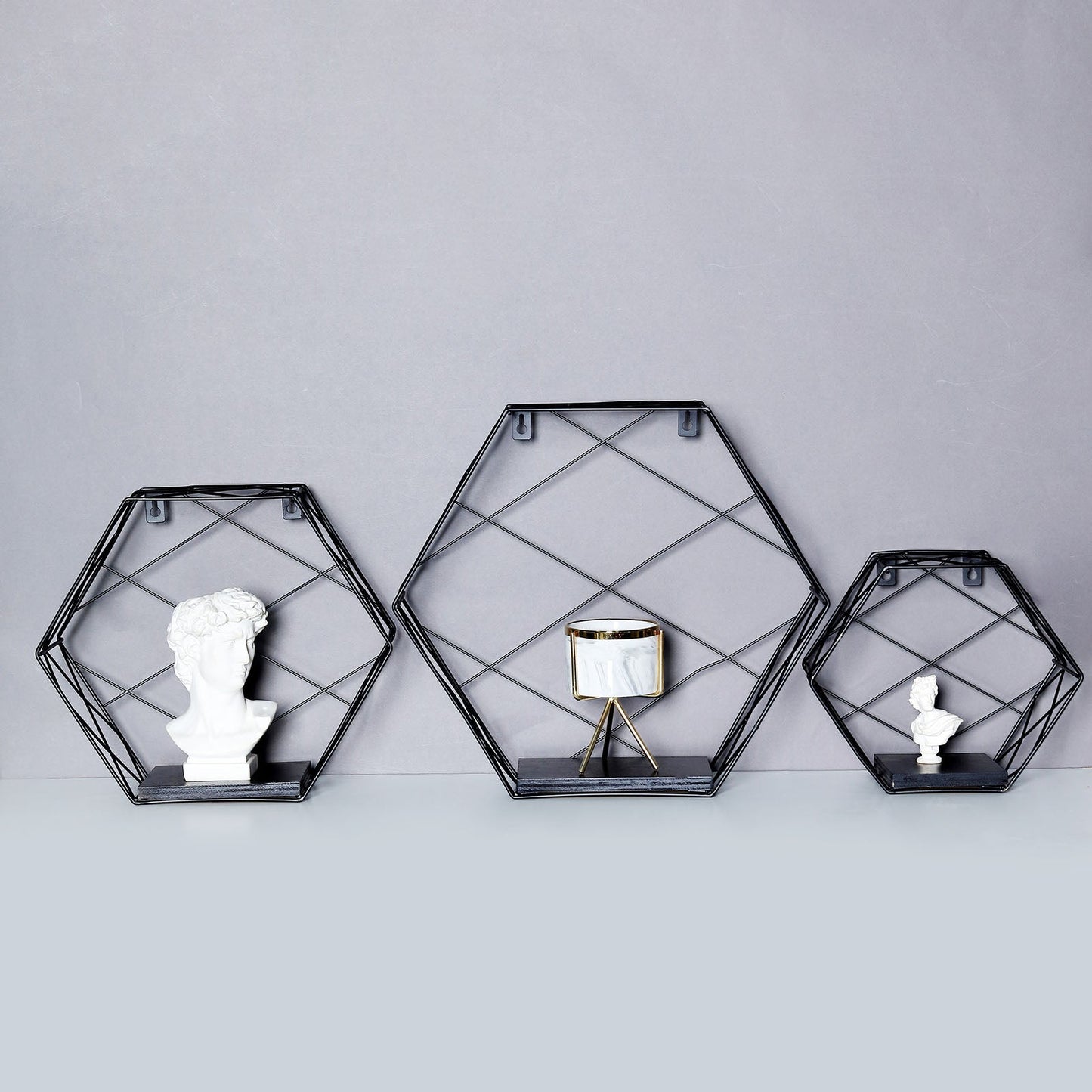 Black hexagonal floating wall shelves, decorative geometric design.