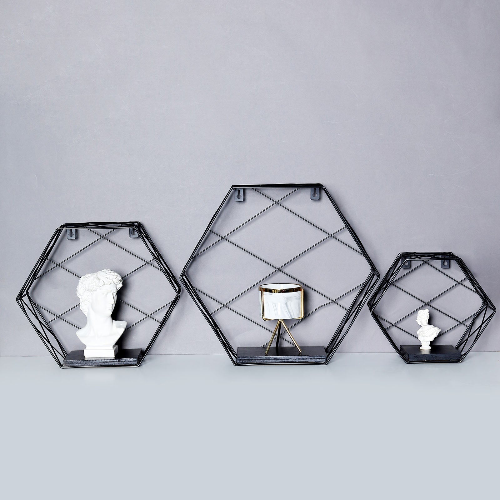 Black hexagonal floating wall shelves, decorative geometric design.