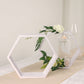 Whitewashed hexagon wood centerpieces with greenery and floral accents.
