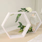 Whitewashed hexagon wood centerpiece with greenery and flowers.