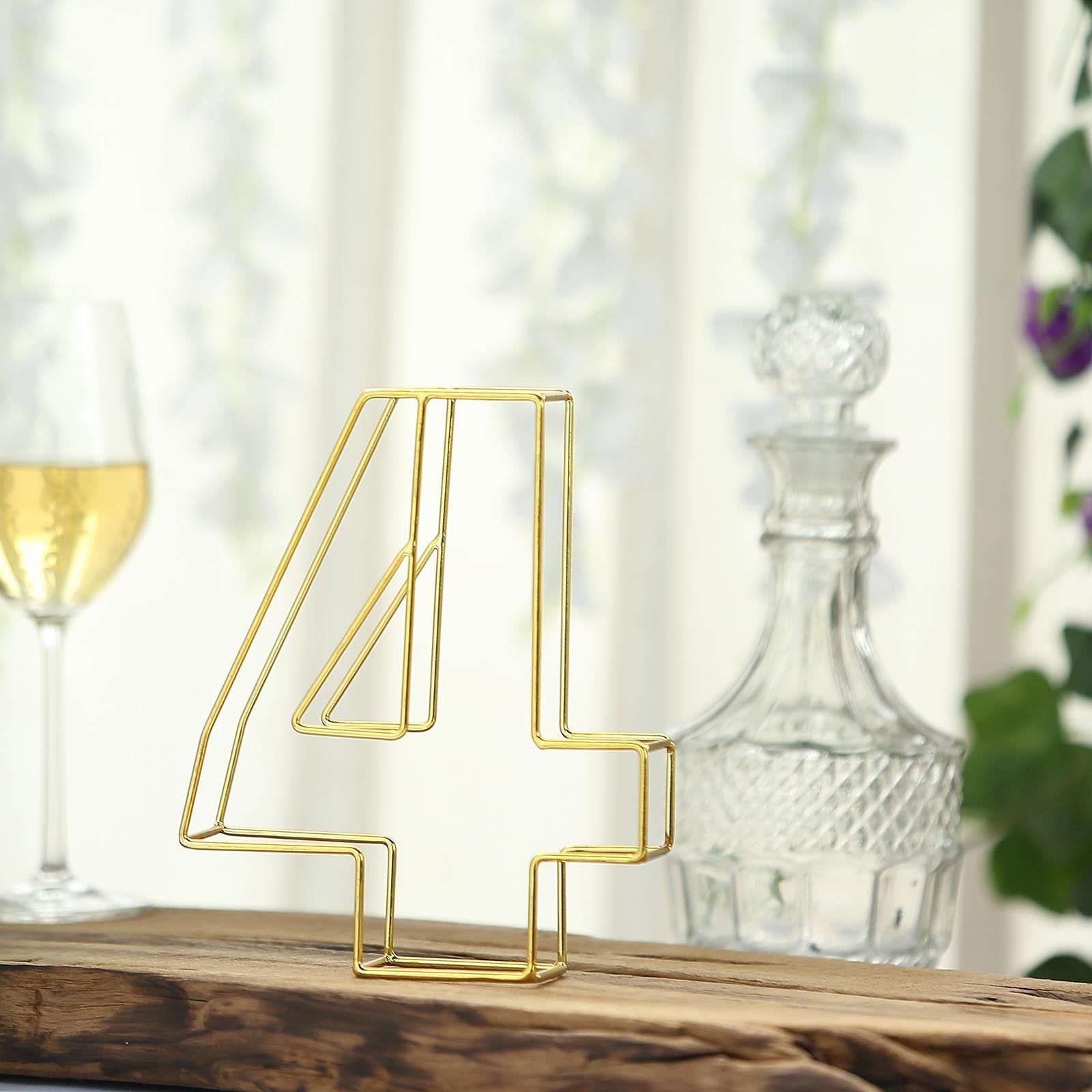 Gold freestanding 3D decorative number 4 for wedding table settings.