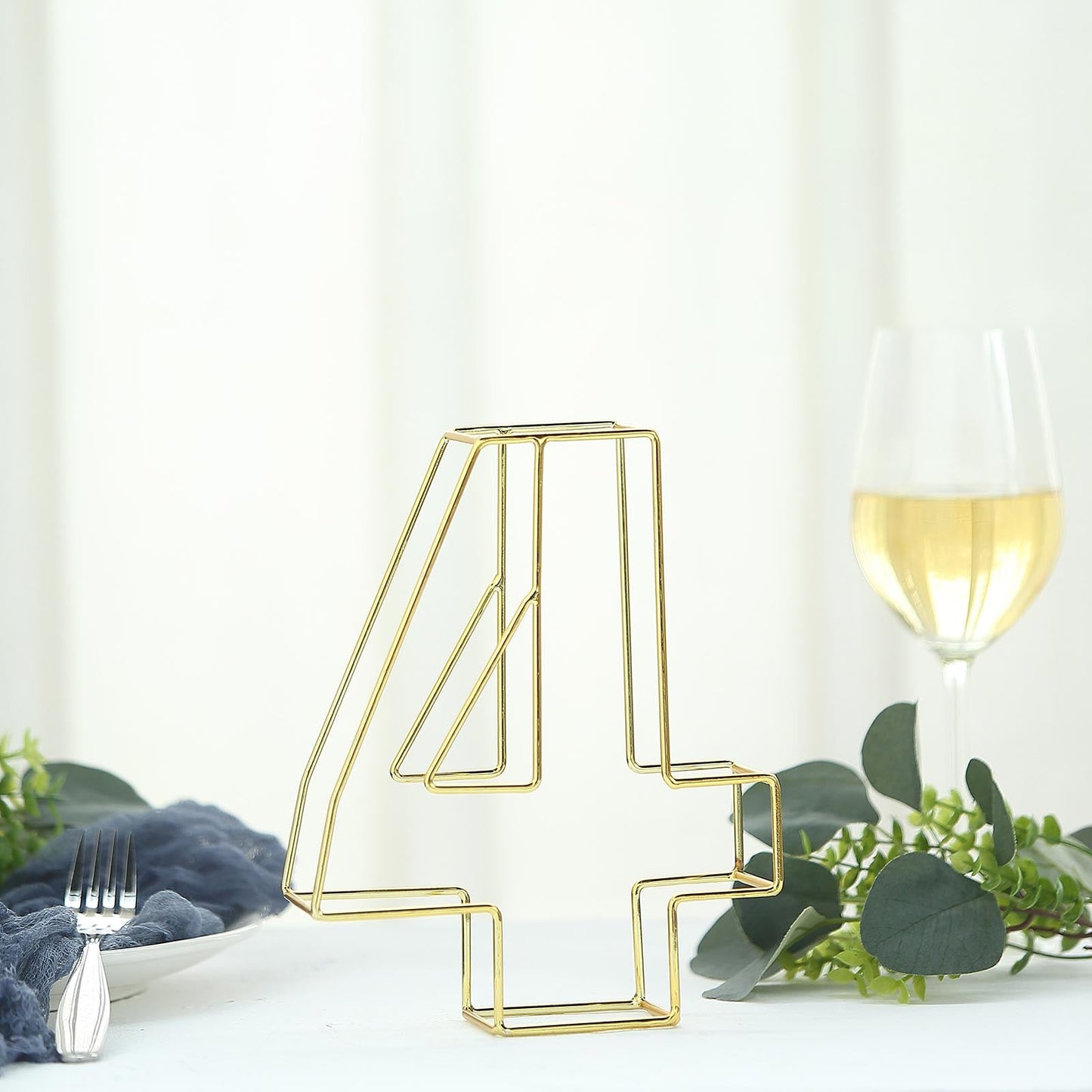 Gold freestanding 3D table number "4" for weddings and events.