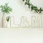 Gold freestanding decorative wire letter "L" for wedding centerpiece.