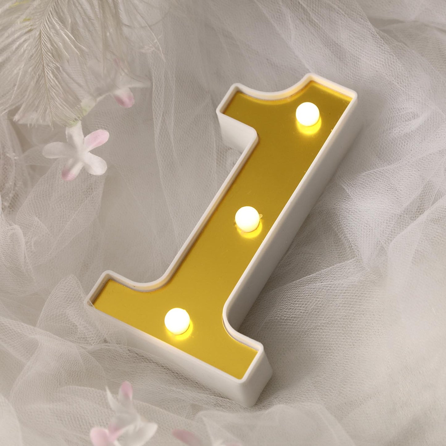 Gold 3D marquee number "1" with warm white LED lights.