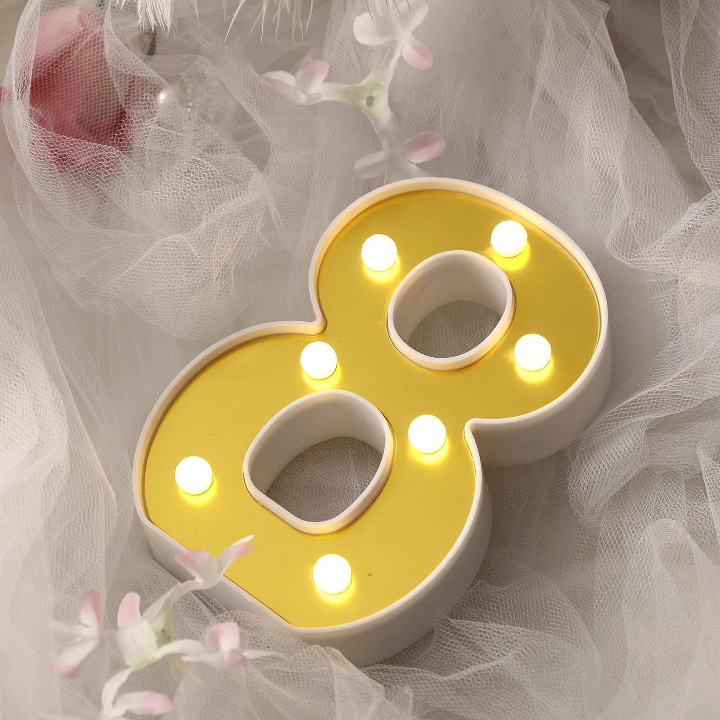 Gold 3D marquee number 8 with warm white LED lights.