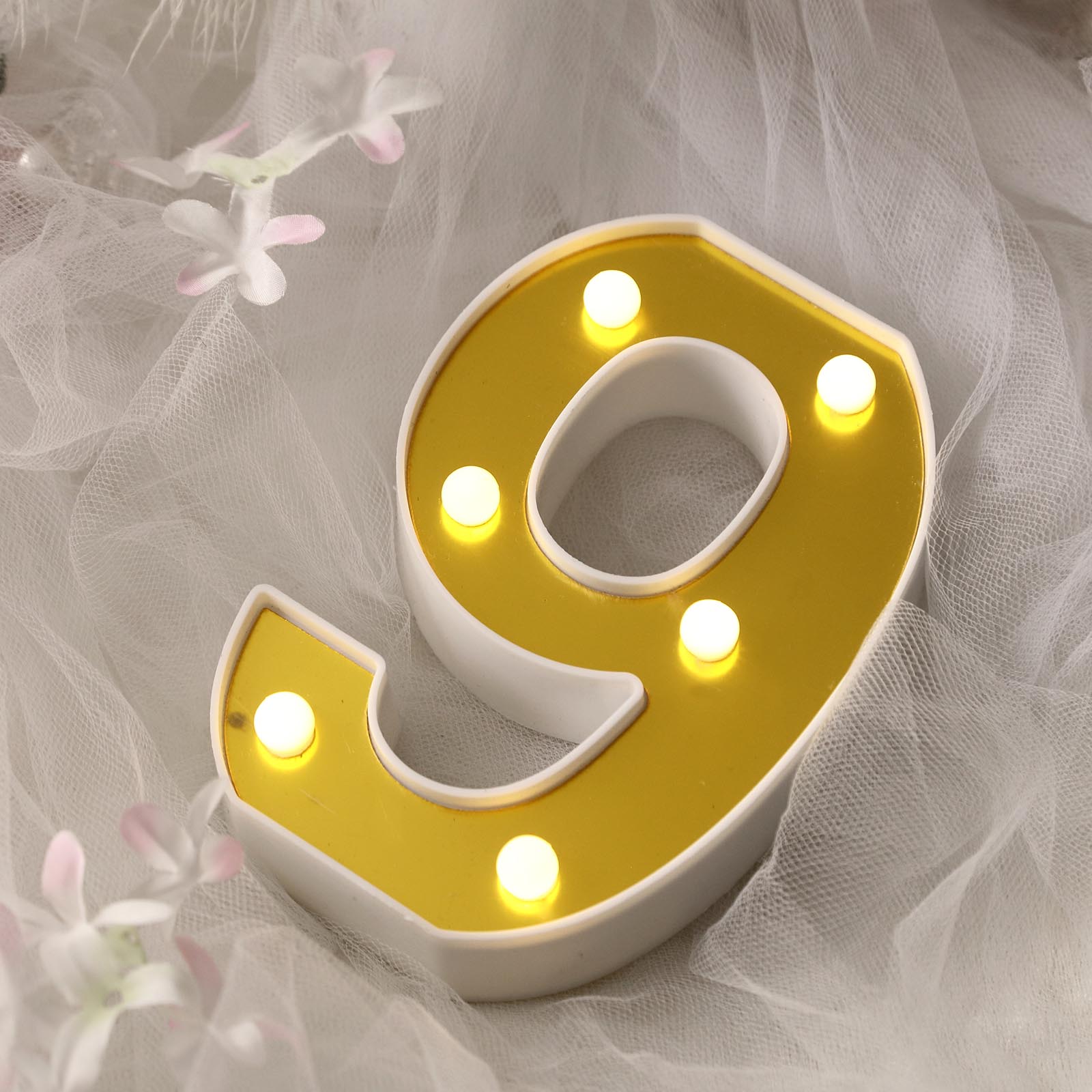 Warm white 3D marquee number 9 with LED lights.