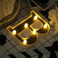Warm white 3D marquee letter "B" with LED lights.