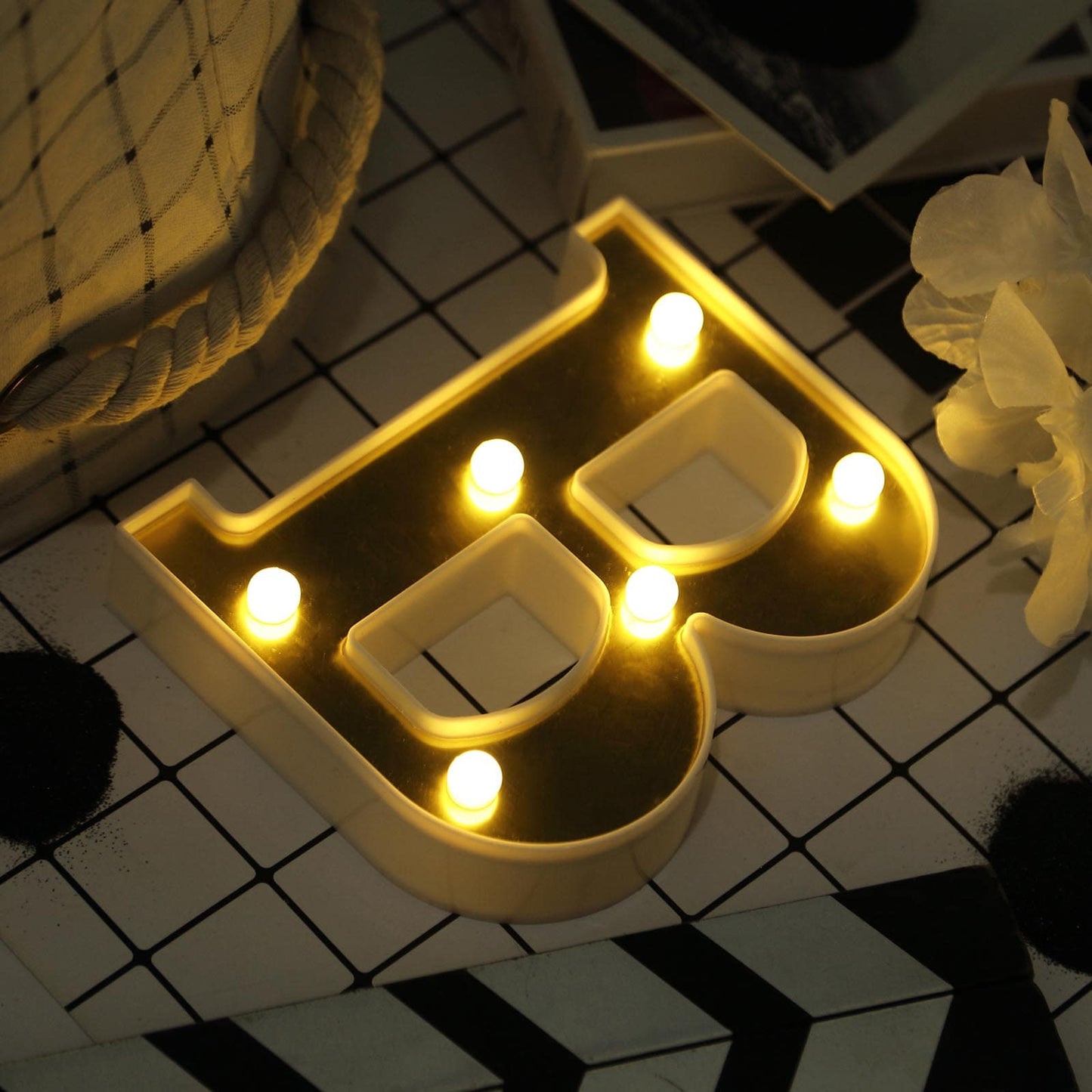 Warm white 3D marquee letter "B" with LED lights.