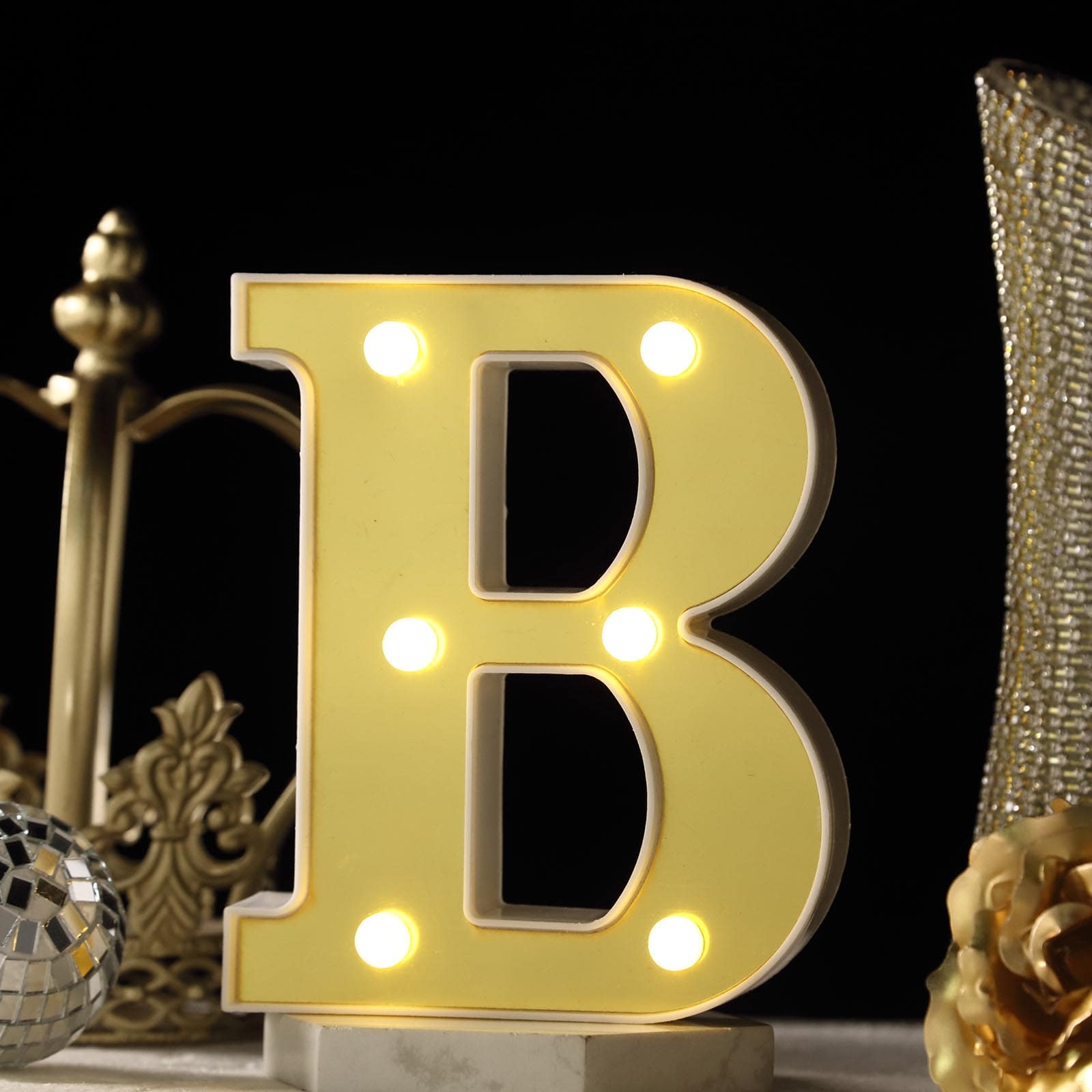 Gold 3D marquee letter "B" with warm white LED lights.