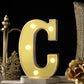 Gold 3D marquee letter 'C' with warm white LED lights.