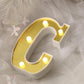 Gold 3D marquee letter "C" with warm white LED lights.