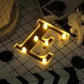 Gold 3D marquee letter "E" with warm white LED lights.