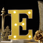 Warm white 3D marquee letter "E" with LED lights.