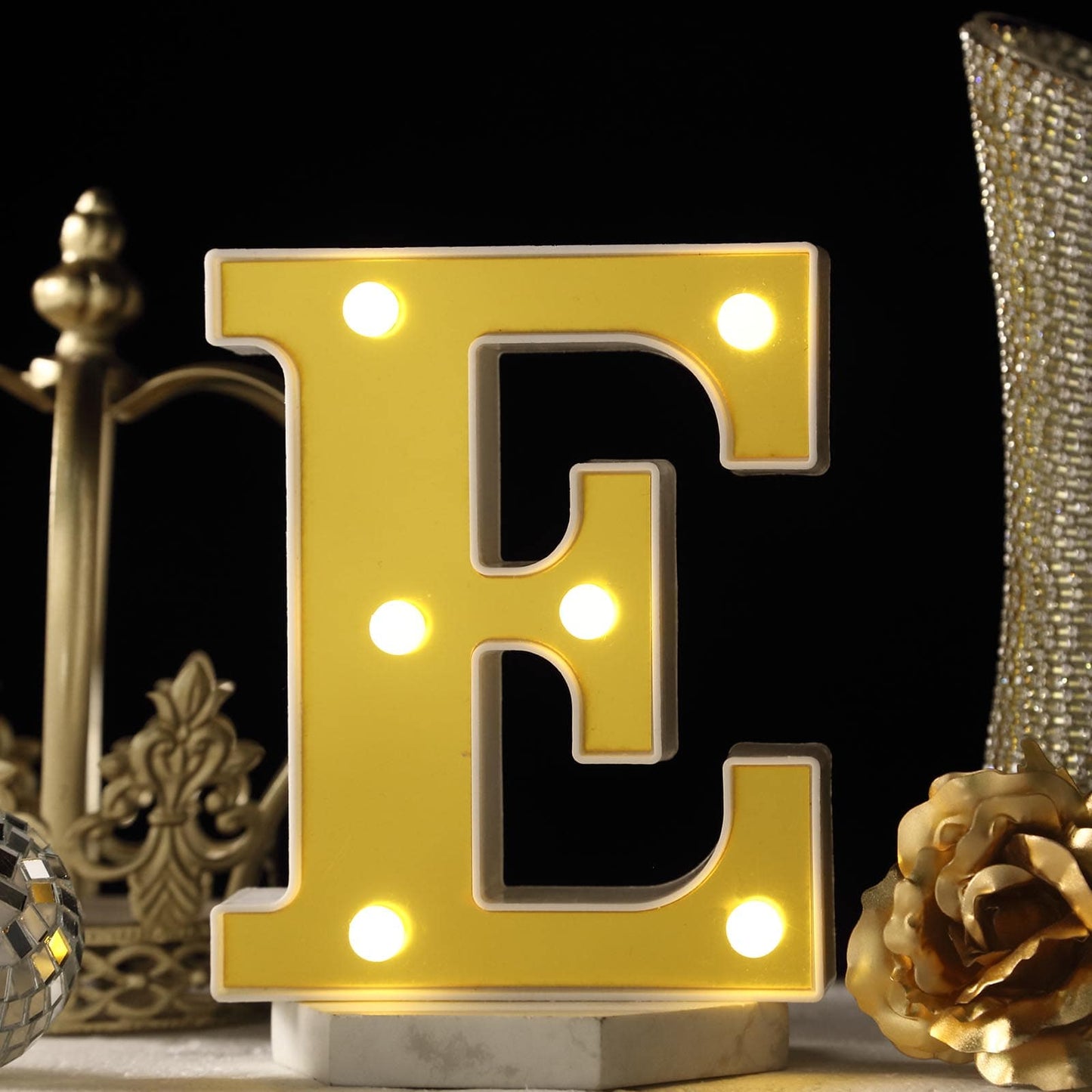 Warm white 3D marquee letter "E" with LED lights.