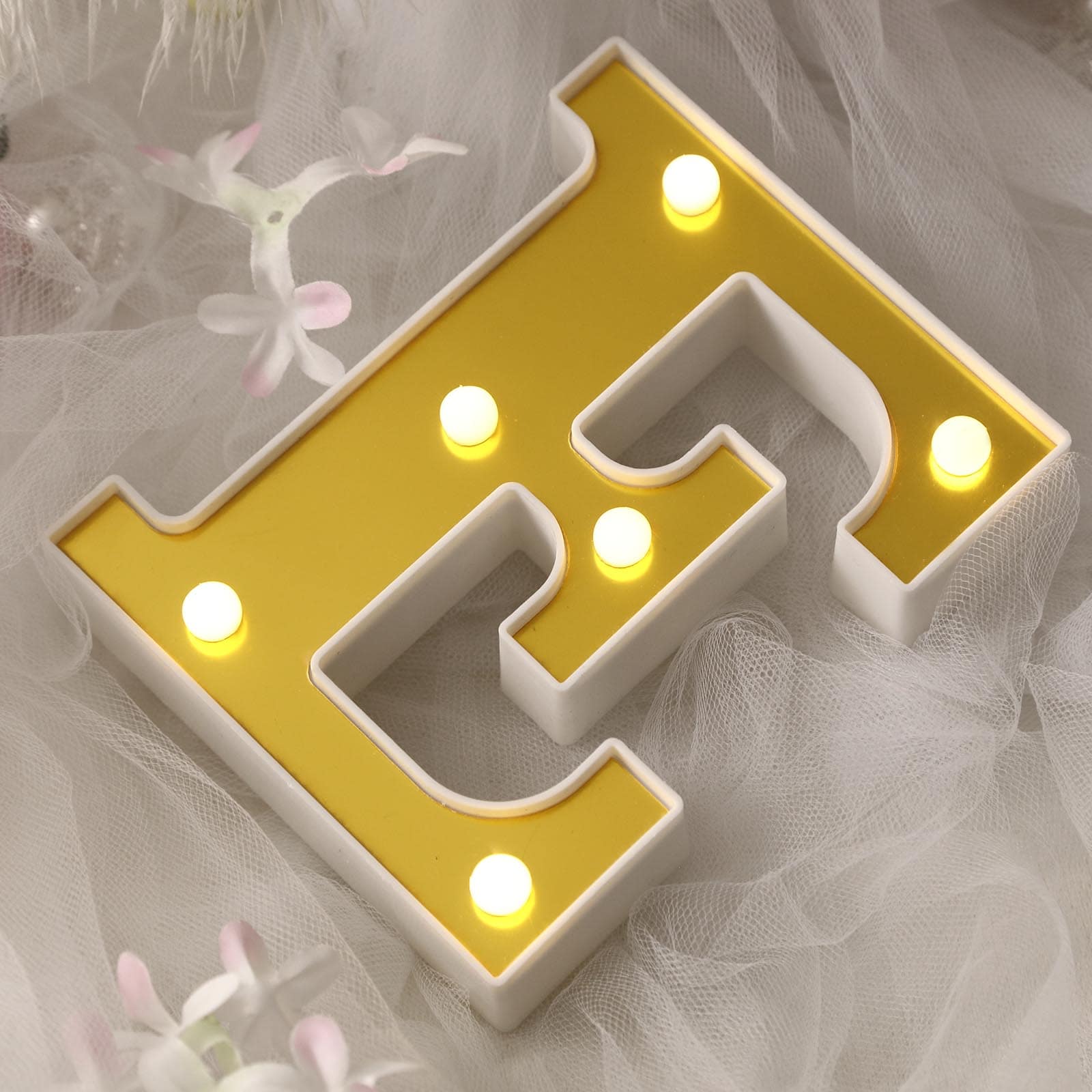 Gold 3D marquee letter "E" with warm white LED lights