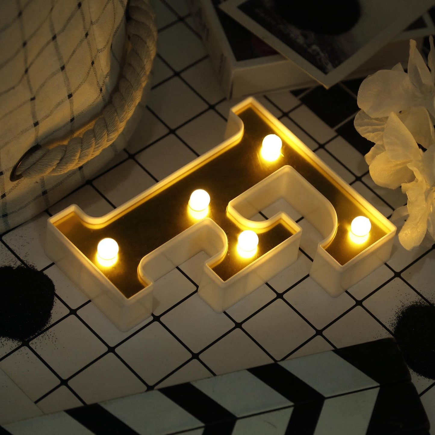 Gold 3D marquee letter "F" with warm white LED lights.