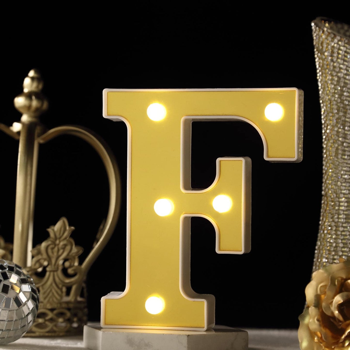Warm white light up letter "F" with 5 LED bulbs.