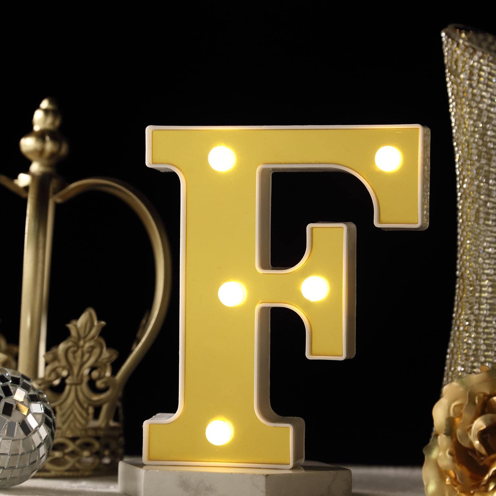 Warm white light up letter "F" with 5 LED bulbs.