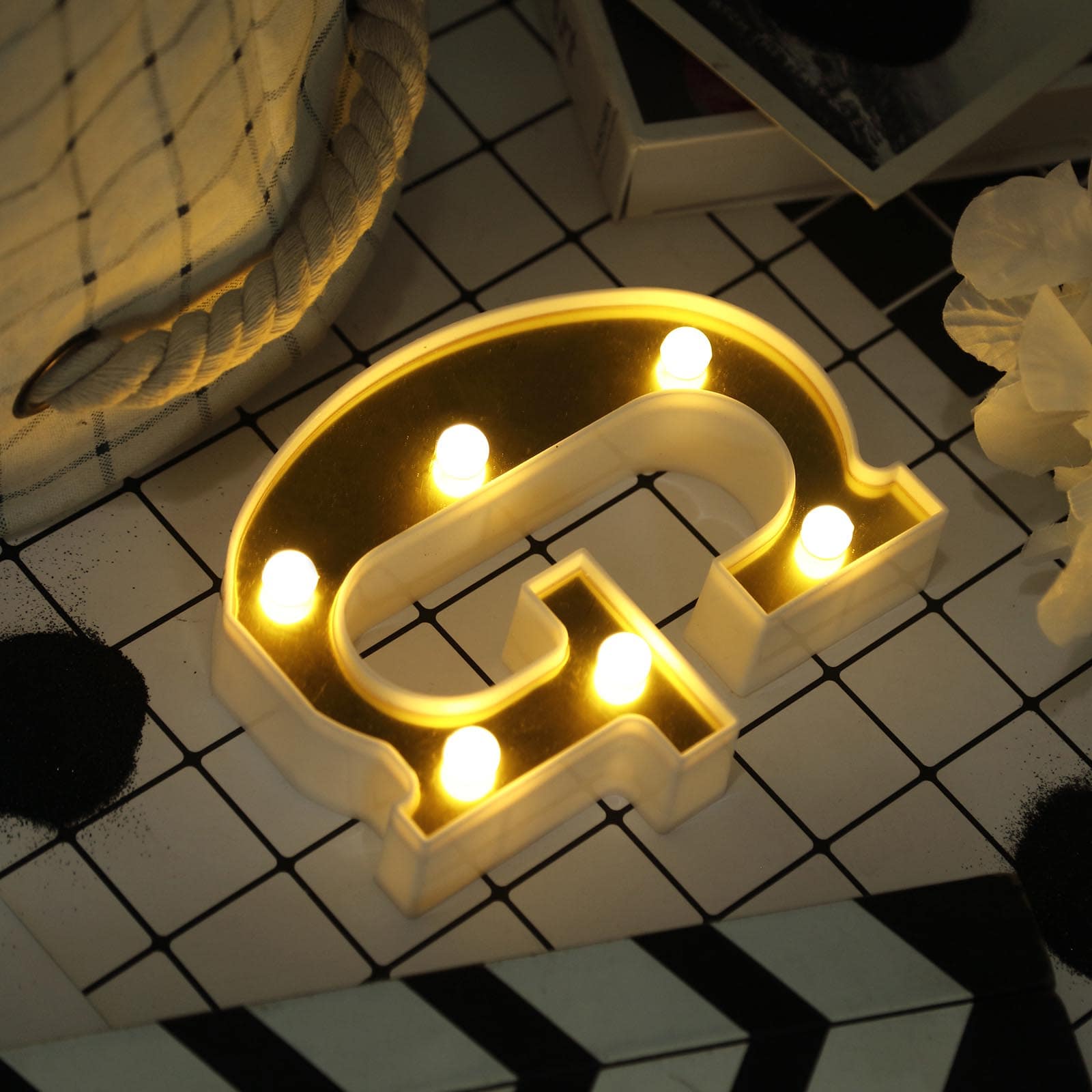 Gold 3D marquee letter "G" with warm white LED lights.
