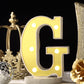 Gold 3D marquee letter "G" with warm white LED lights.