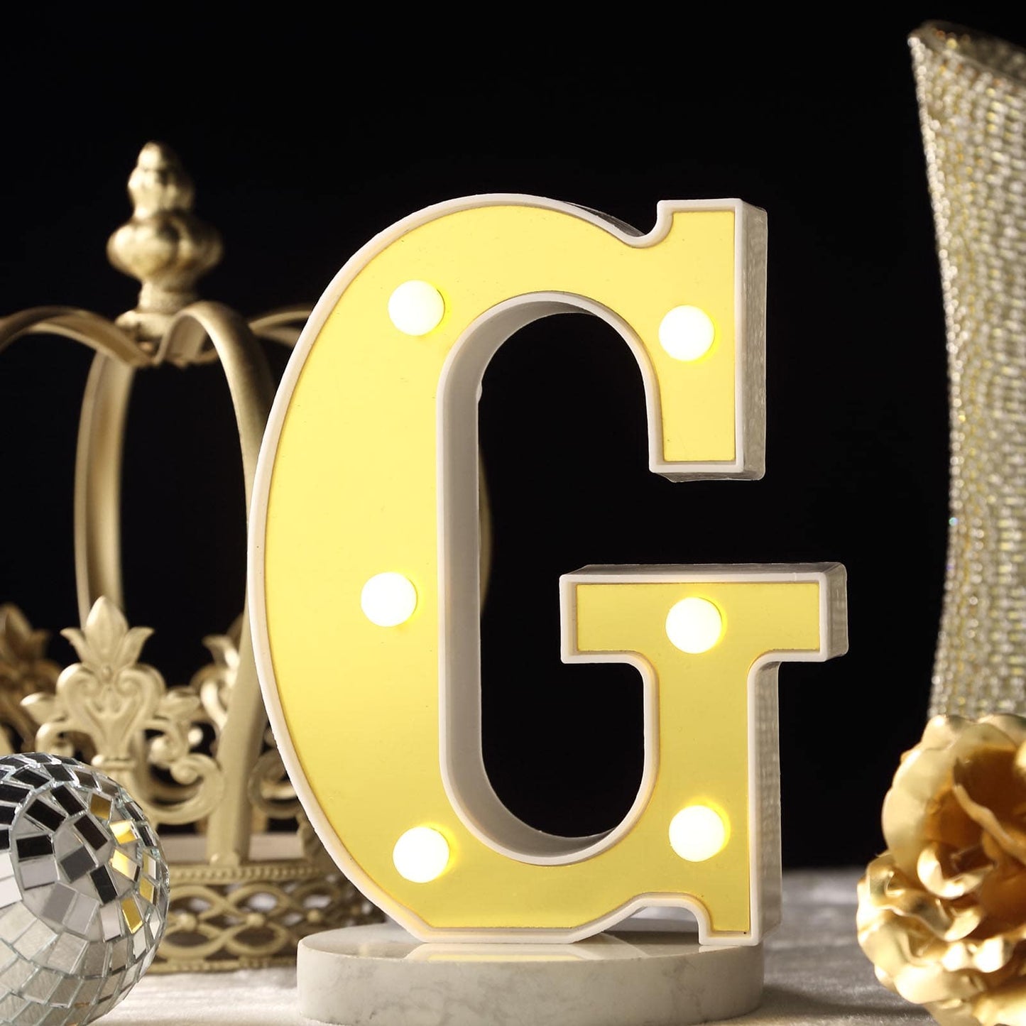 Gold 3D marquee letter "G" with warm white LED lights.