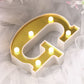 Gold 3D marquee letter 'G' with warm white LED lights.