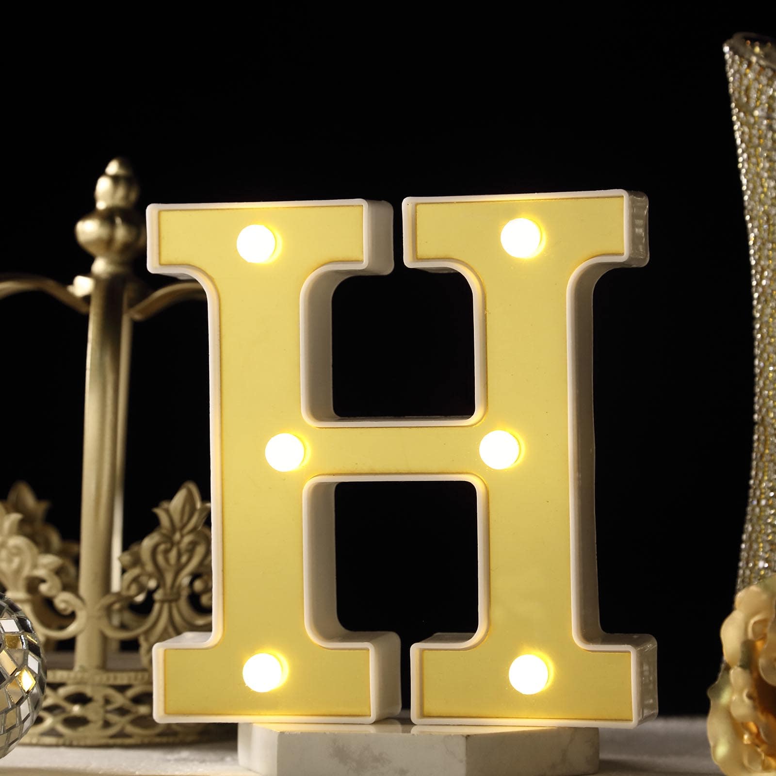 Warm white 3D marquee letter "H" with LED lights.