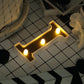Gold 3D marquee letter "I" with warm white LED lights.