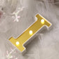 Gold 3D marquee letter "I" with warm white LED lights.