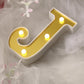 Gold 3D marquee letter 'J' with warm white LED lights.