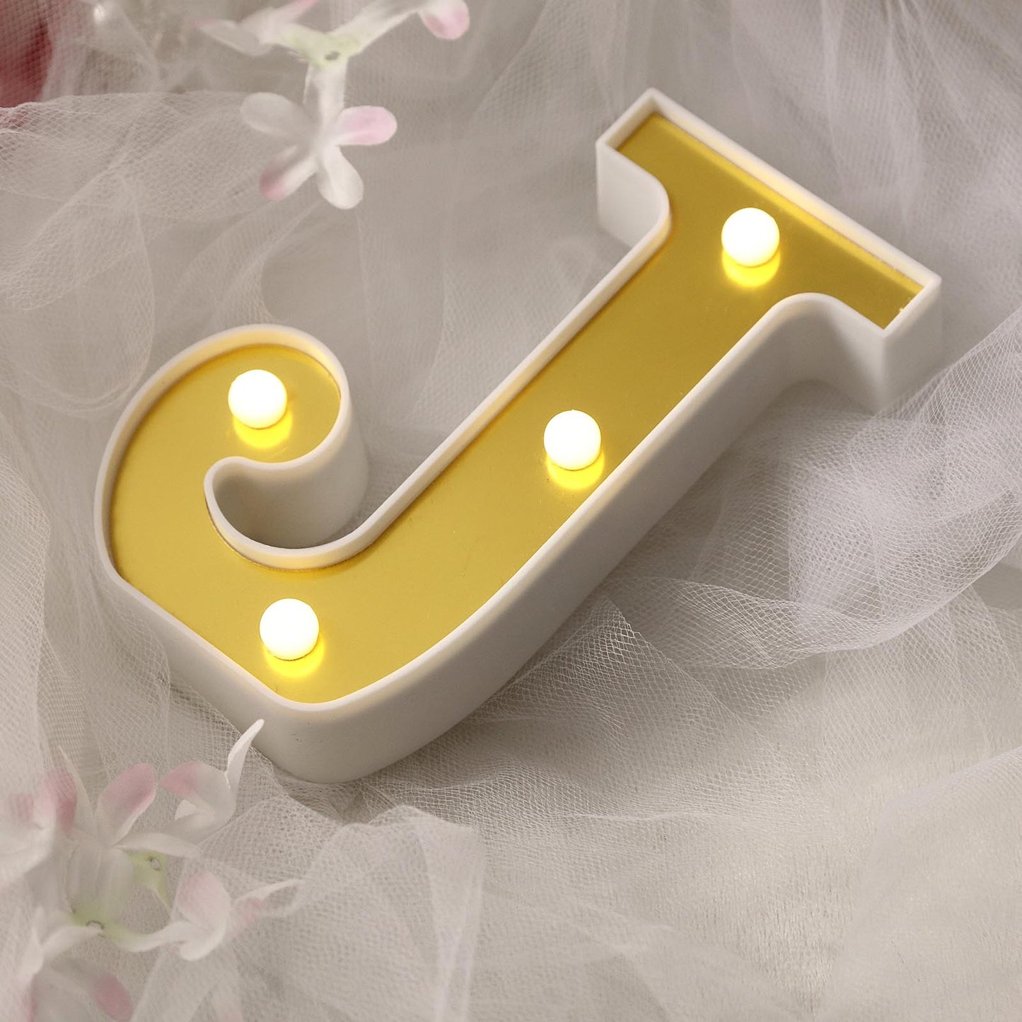 Gold 3D marquee letter 'J' with warm white LED lights.