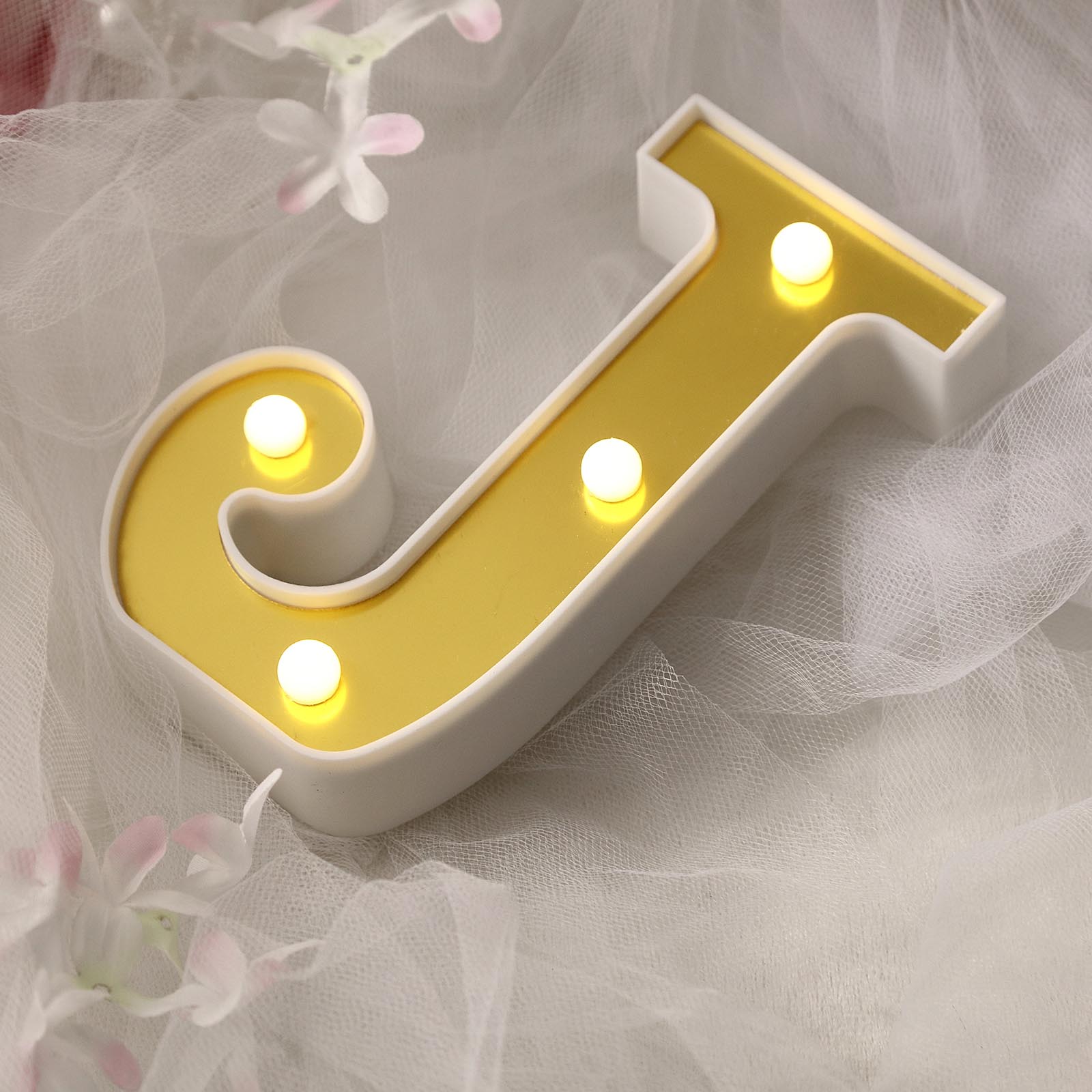 Gold 3D marquee letter 'J' with warm white LED lights.