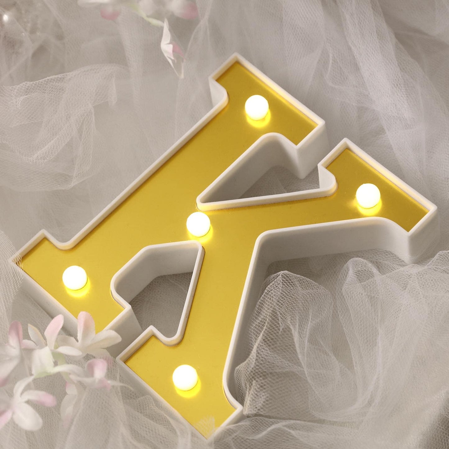 Gold 3D marquee letter "K" with warm white LED lights.