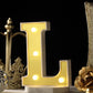 Warm white 3D marquee letter "L" with LED lights.