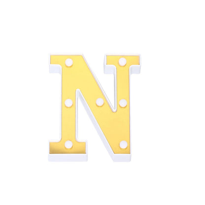 Gold 3D marquee letter "N" with warm white LED lights.