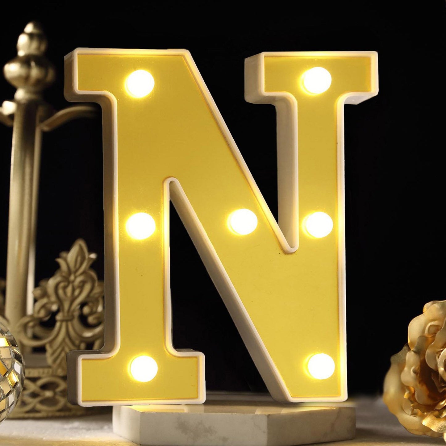 Warm white 3D marquee letter "N" with LED lights.