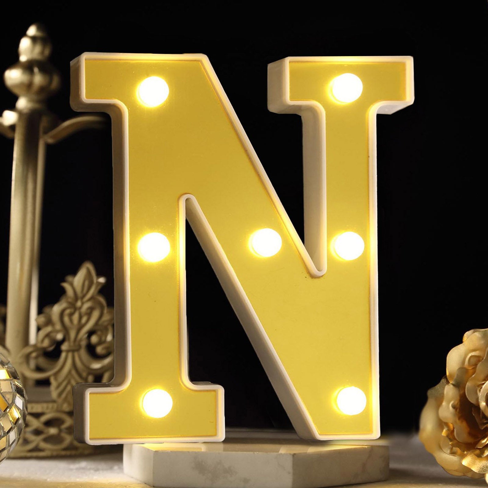 Warm white 3D marquee letter "N" with LED lights.