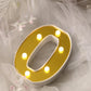 Gold 3D marquee letter "O" with warm white LED lights.