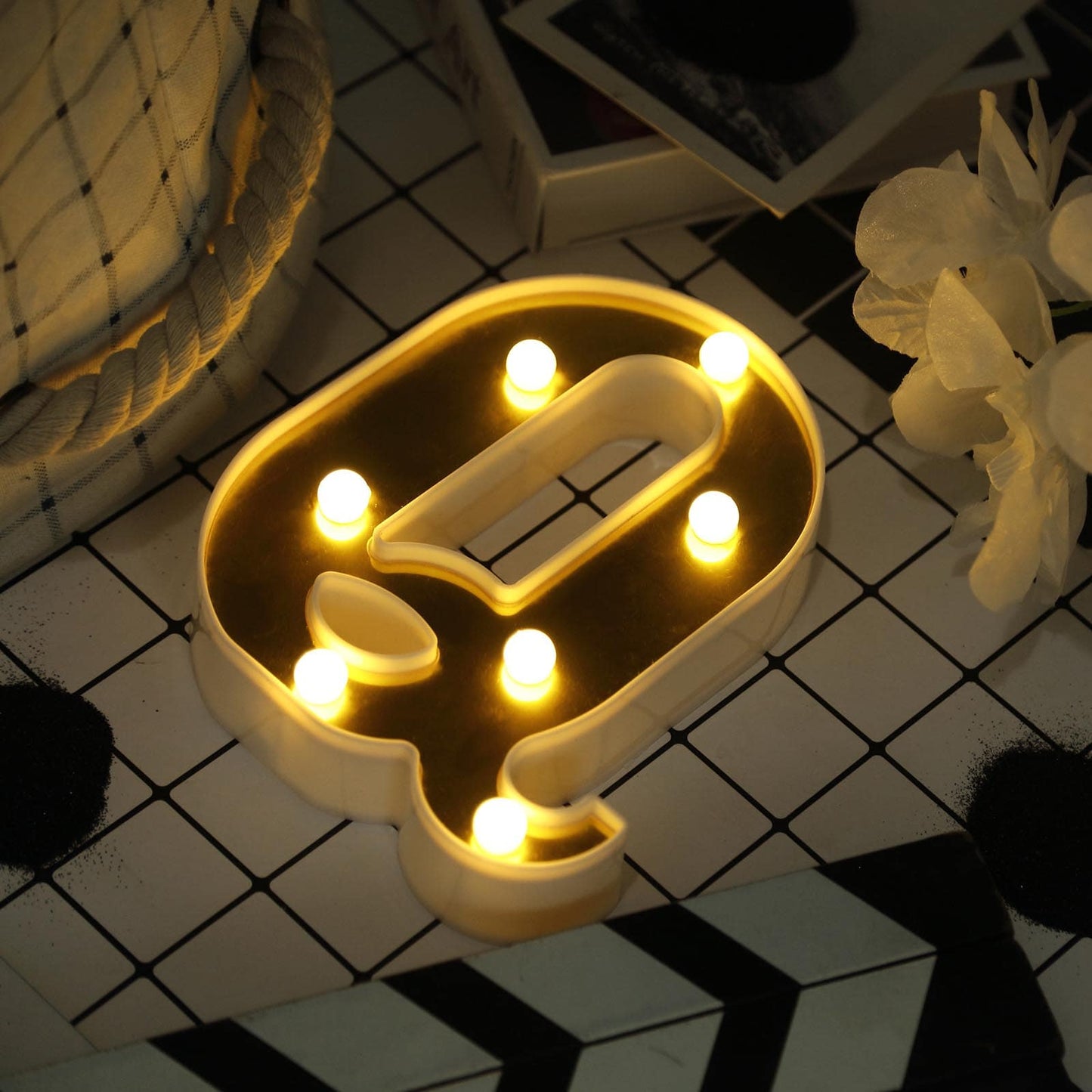 Gold 3D marquee letter "Q" with warm white LED lights.