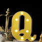 Gold 3D marquee letter "Q" with warm white LED lights.