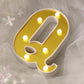 Gold 3D marquee letter "Q" with warm white LED lights.