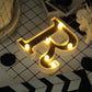 Gold 3D marquee letter "R" with warm white LED lights.