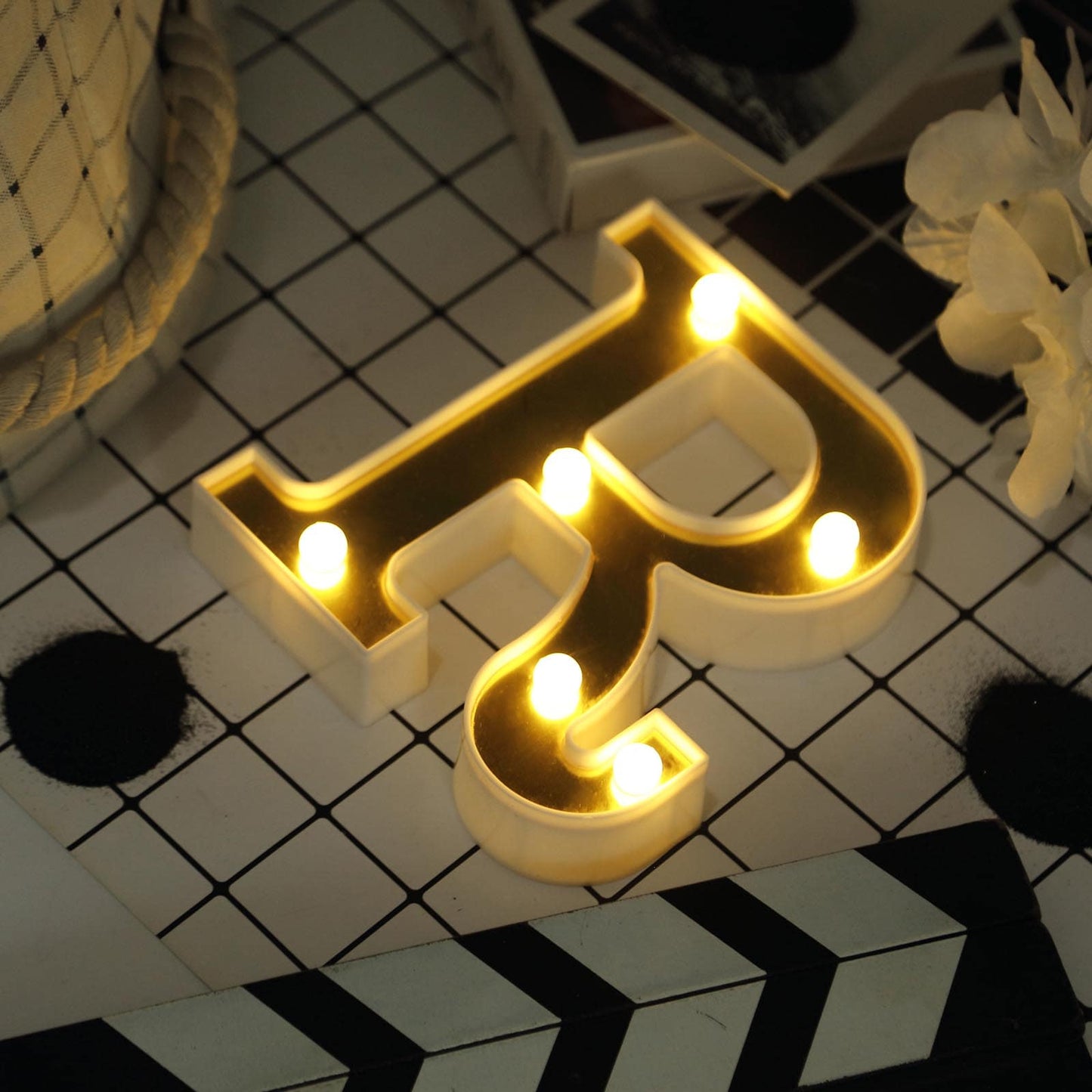 Gold 3D marquee letter "R" with warm white LED lights.
