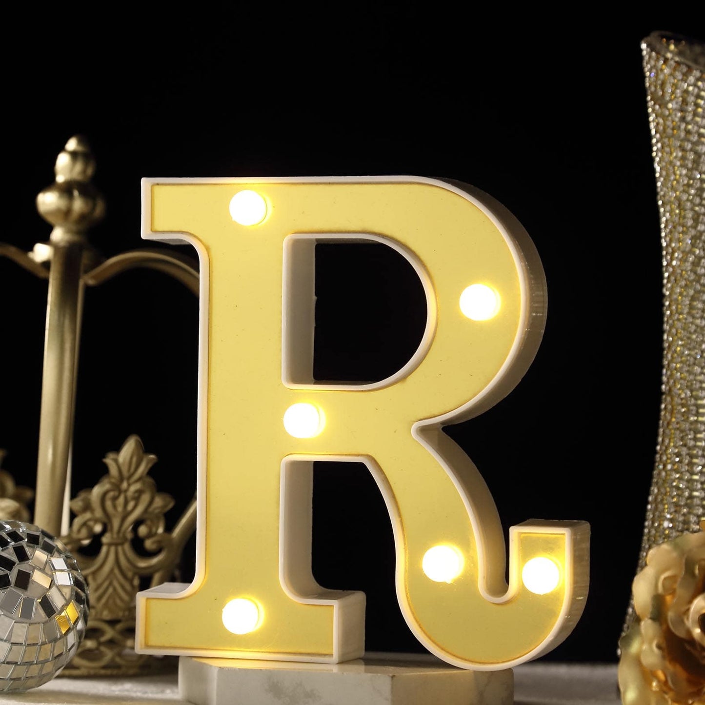 Warm white 3D marquee letter "R" with LED lights.